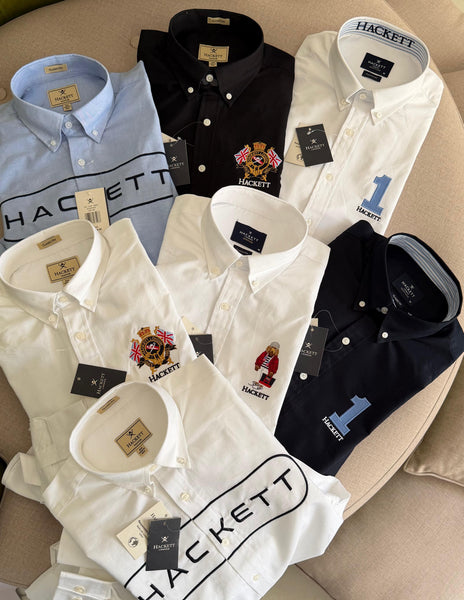 Premium men's shirts collection featuring classic fit button-down shirts in white, black, navy and light blue with embroidered crest, bear and number 1 logo designs