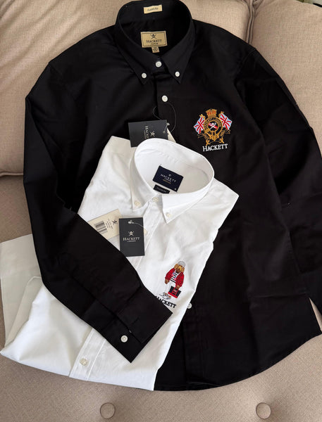 Premium men's shirts collection featuring classic fit button-down shirts in white, black, navy and light blue with embroidered crest, bear and number 1 logo designs