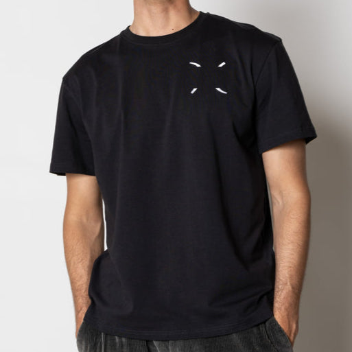 Man wearing a black t-shirt with a small white logo against a plain background