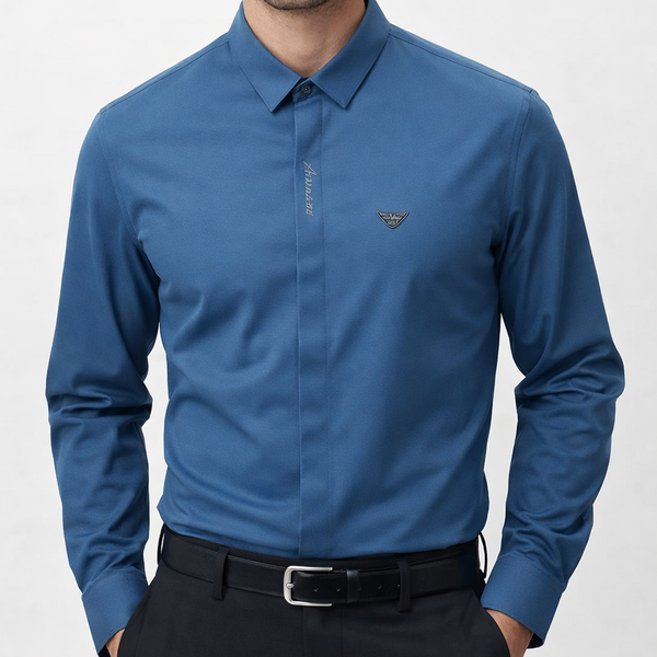 "Man wearing branded  steel blue long-sleeve polo shirt with EA eagle logo badge, inside a luxury Armani boutique"

