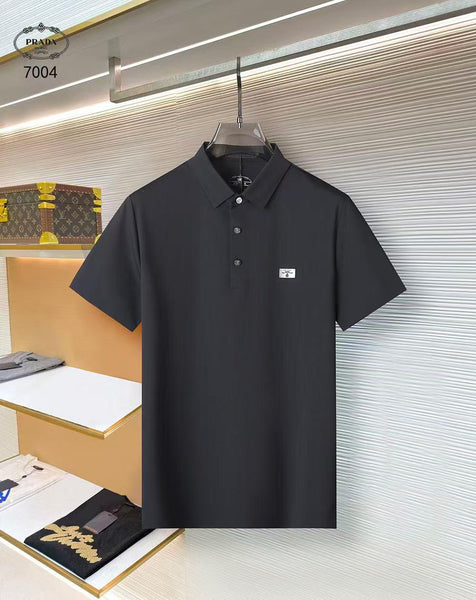Black polo shirt on a hanger with Prada logo in a store setting