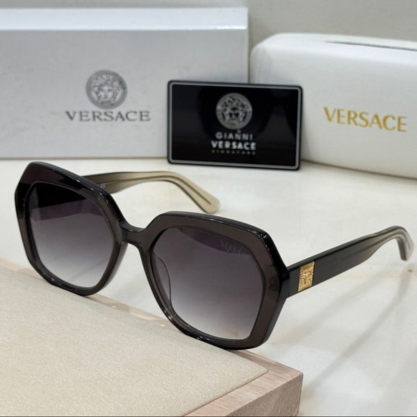 Versace sunglasses with branded case and box on a light background
