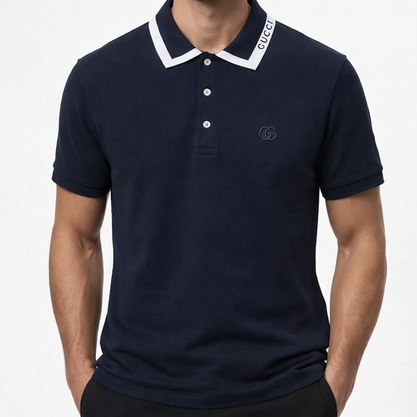 "Branded i men's navy blue short-sleeve piqué polo shirt with white contrast collar stripe T-shirt , Brand text on collar, tonal GG chest logo and metallic placket buttons, displayed on hanger in luxury boutique"