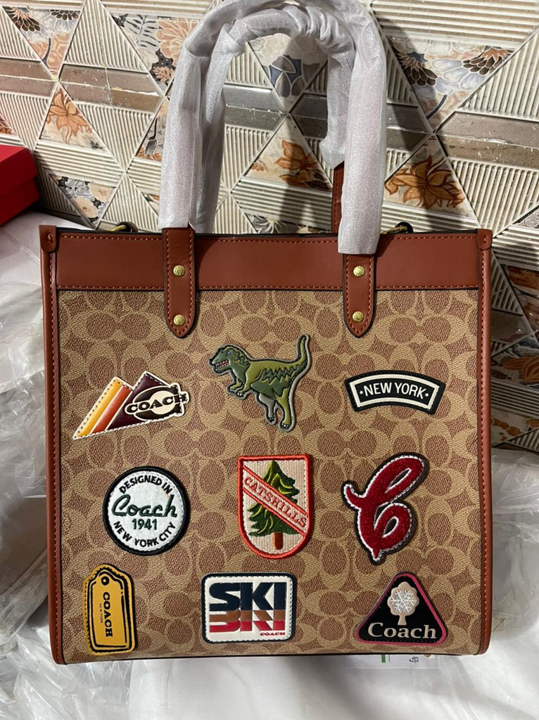 Field Tote 40 in Signature Canvas with Souvenir Patches and Pins