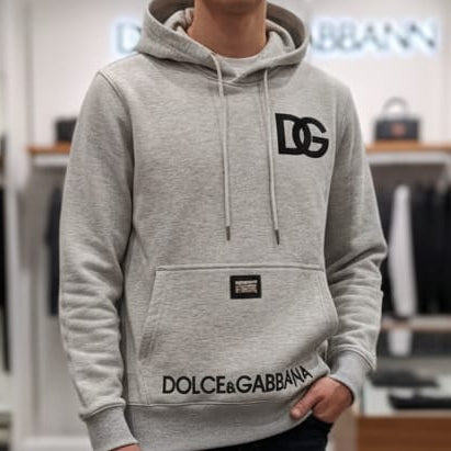 Person wearing a Dolce & Gabbana hoodie in a clothing store