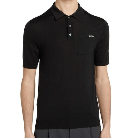 Man wearing a black polo shirt and shorts on a white background