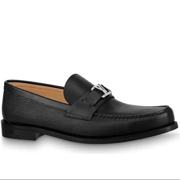 Black loafers with a silver buckle on a white background